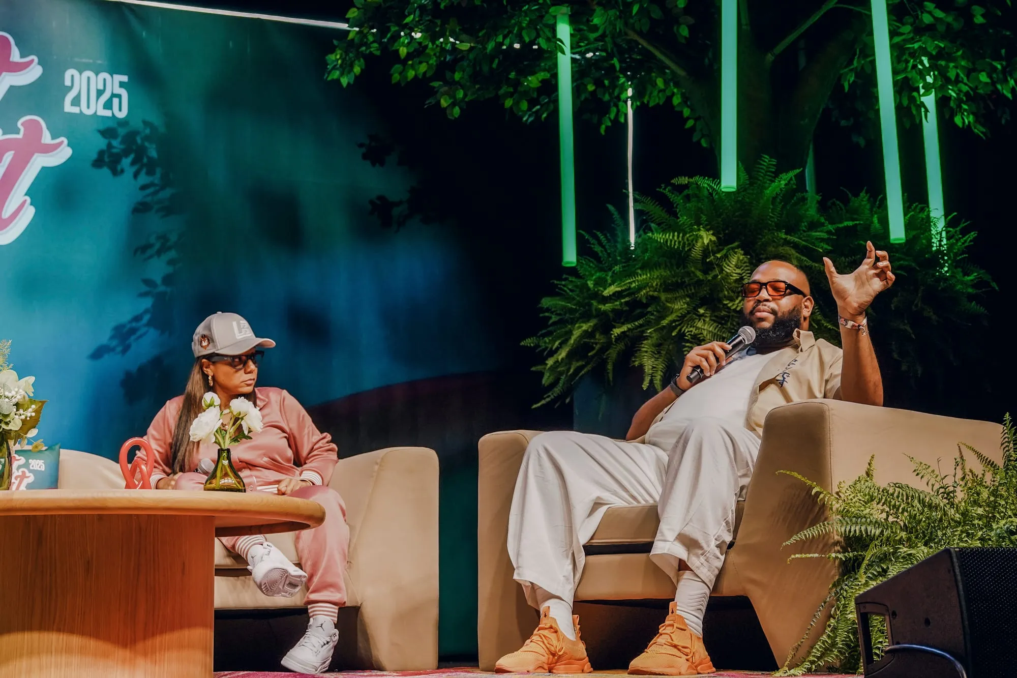 Marlon Avery holding a microphone on a panel stage